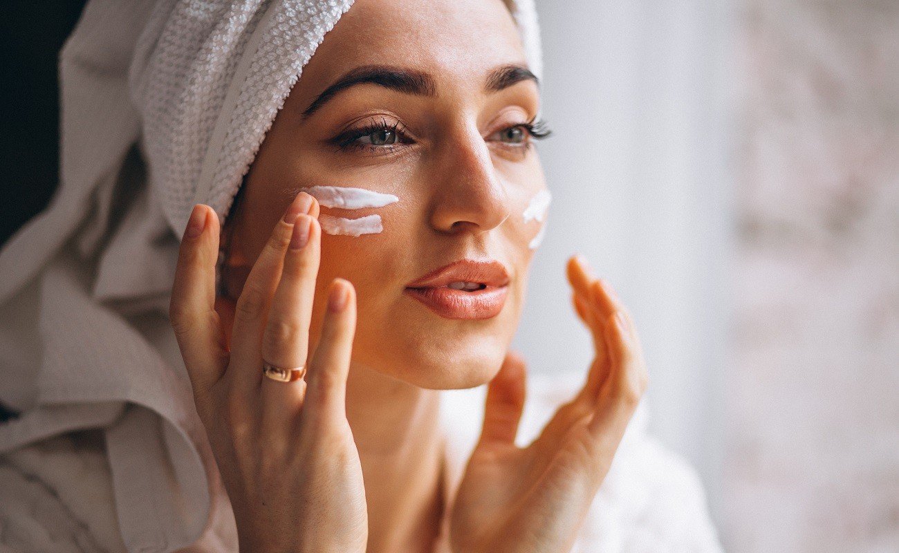 Woman applying face cream